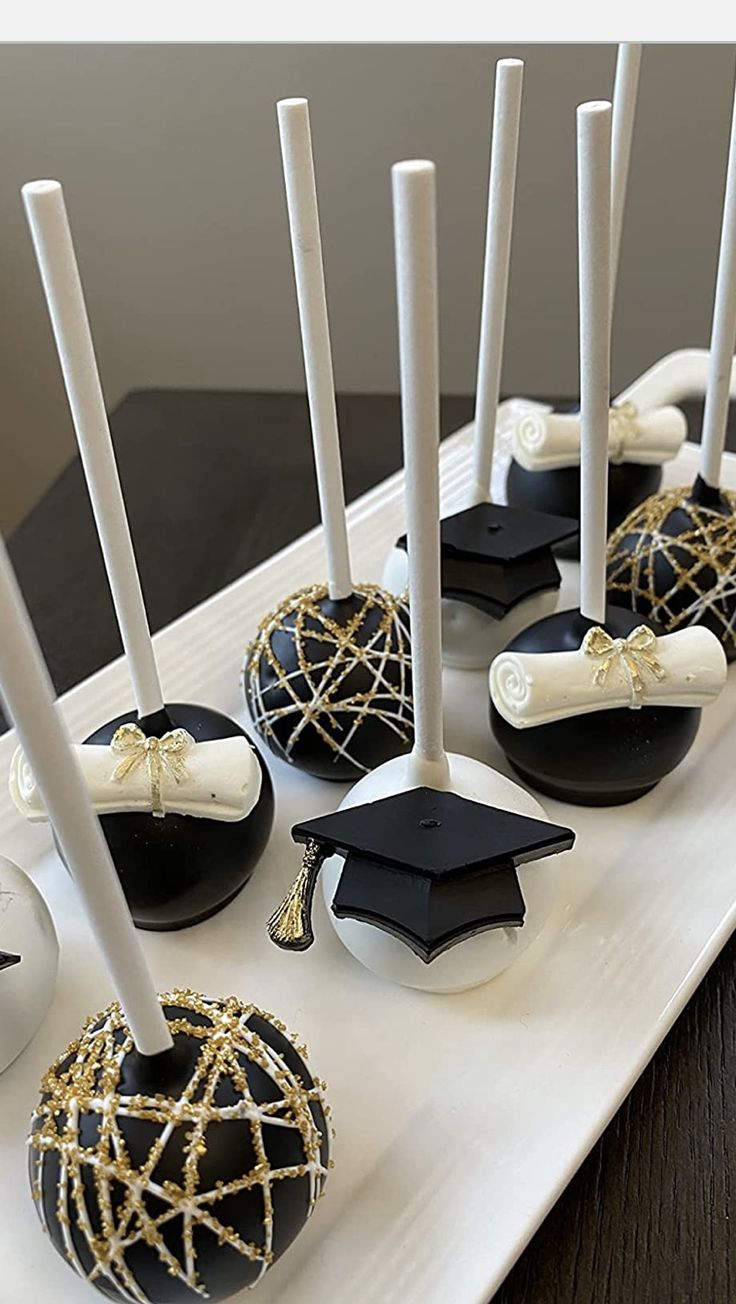 some black and white cake pops are on a tray