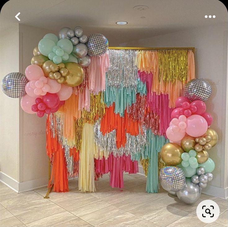 balloons and streamers decorate the entrance to a party