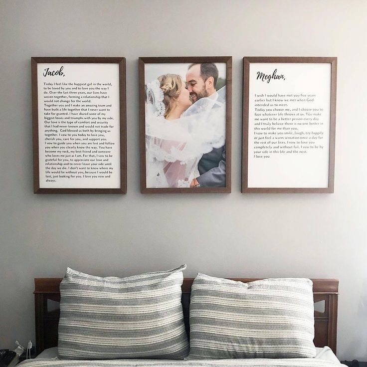 a bed with two framed pictures on the wall above it, and a couple's wedding vows