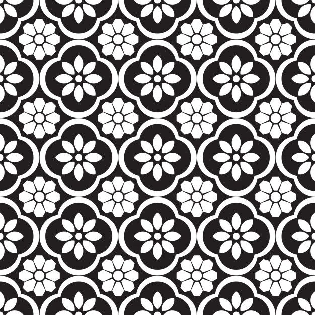 a black and white flower pattern with circles in the center, on a dark background