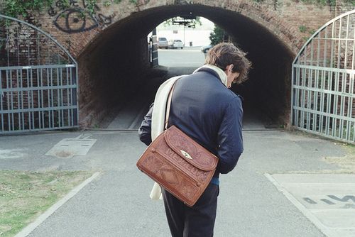 a man with a briefcase walking into a tunnel