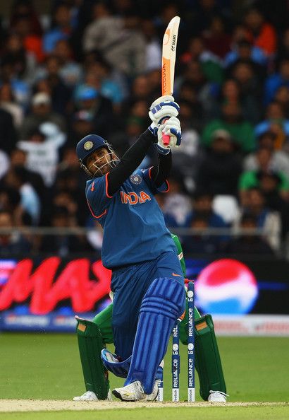 a man holding a bat on top of a field