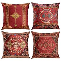 four pillows with different designs on them, each one in red and the other in gold