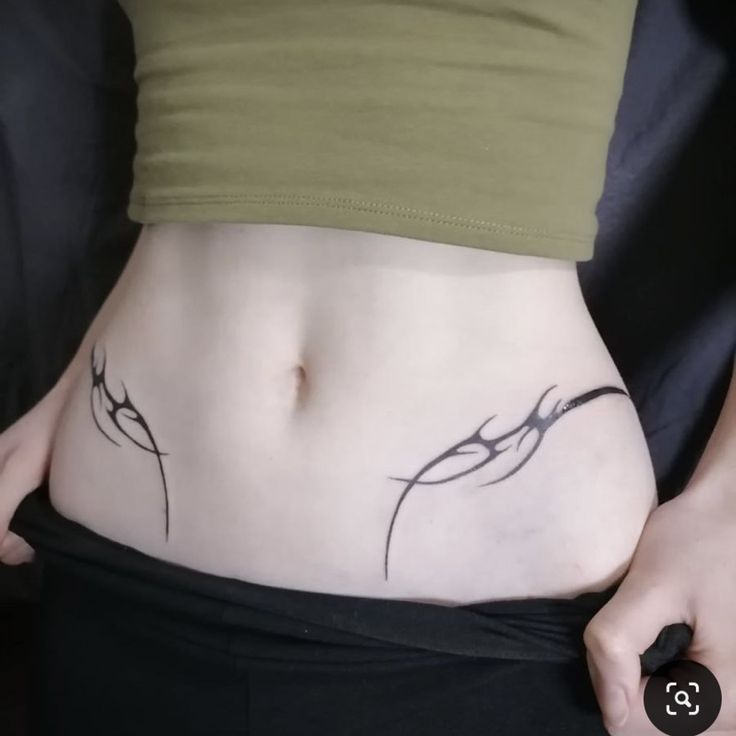 a close up of a person with a tattoo on their stomach