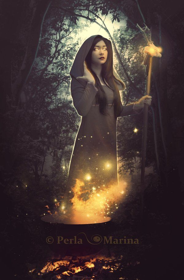 a woman holding a wand in her hand while standing next to a forest filled with fireflies