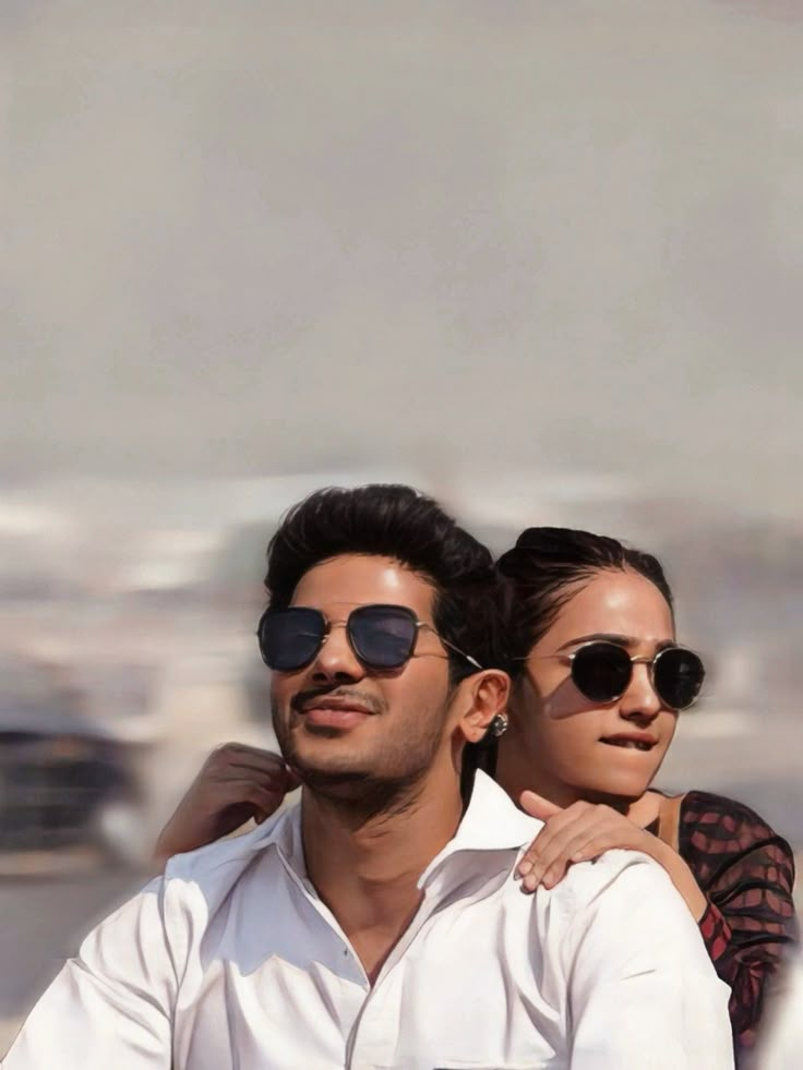 a man and woman riding on the back of a motorcycle