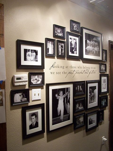 a wall filled with pictures and framed photos