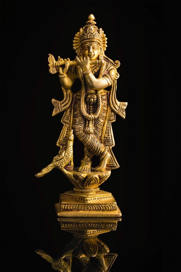 the golden statue of lord ganesha is on display in front of a black background