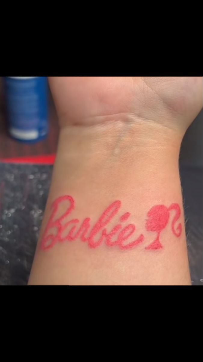 someone has a tattoo on their wrist that says, barbieli? in red ink