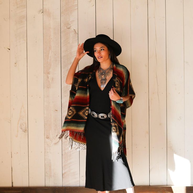 A vivid Southwestern-inspired design defines the pure Good Tidings style of this draped poncho shawl. Relaxed fit. Intended to hit under the hip. For every Navajo Style Poncho you purchase we give 20% to our nonprofit organization who supports children with autism as well as their families and the schools. Thank you for working your magic. One size fits all Size : Apx. 36" by 33" / 91 cm by 84 cmSewn armholes. Dropped shouldersHand washImported Navajo Style Fashion, Western Shawl, Southwestern Style Fashion, Fall Bohemian Woven Poncho, Bohemian Winter Shawl Poncho, Traditional Fall Poncho With Fringe, Folk Style Fall Poncho, One Size Folk Style Poncho Shawl, Native American Style Outfits