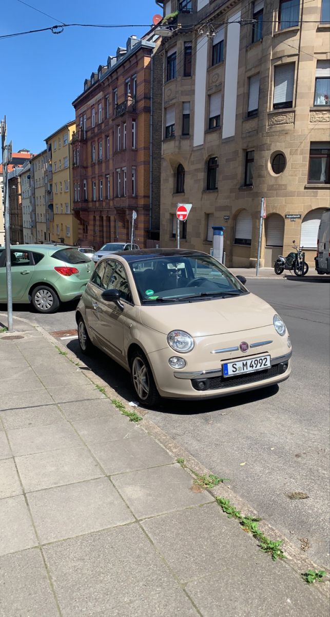 a small car parked on the side of a street