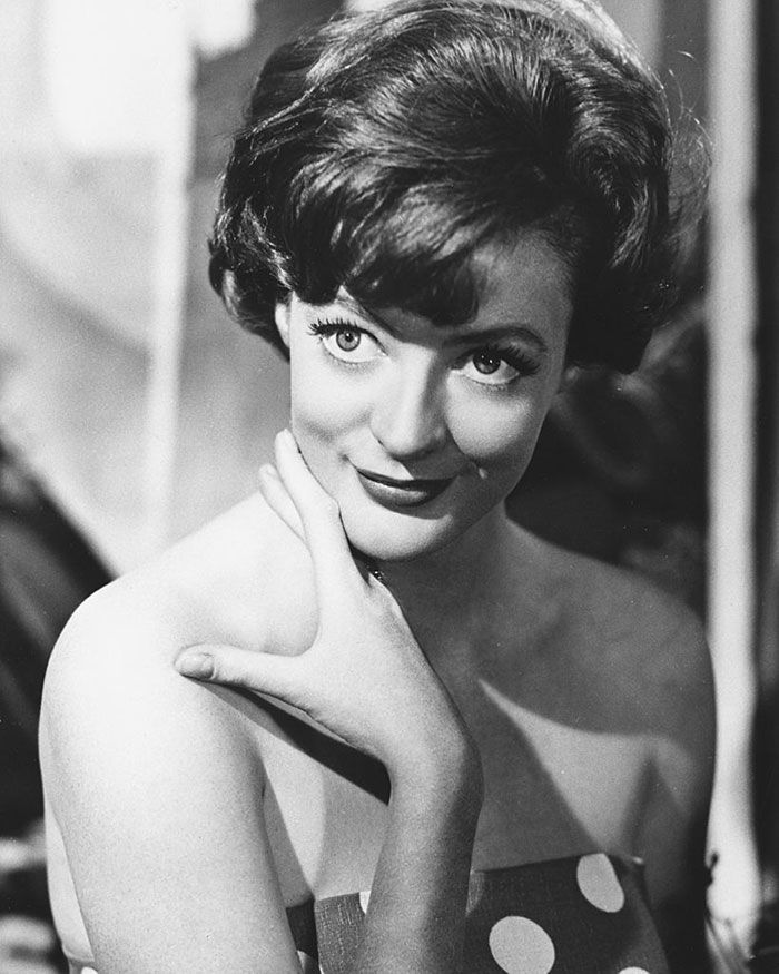 black and white photograph of a woman with polka dots on her dress posing for the camera