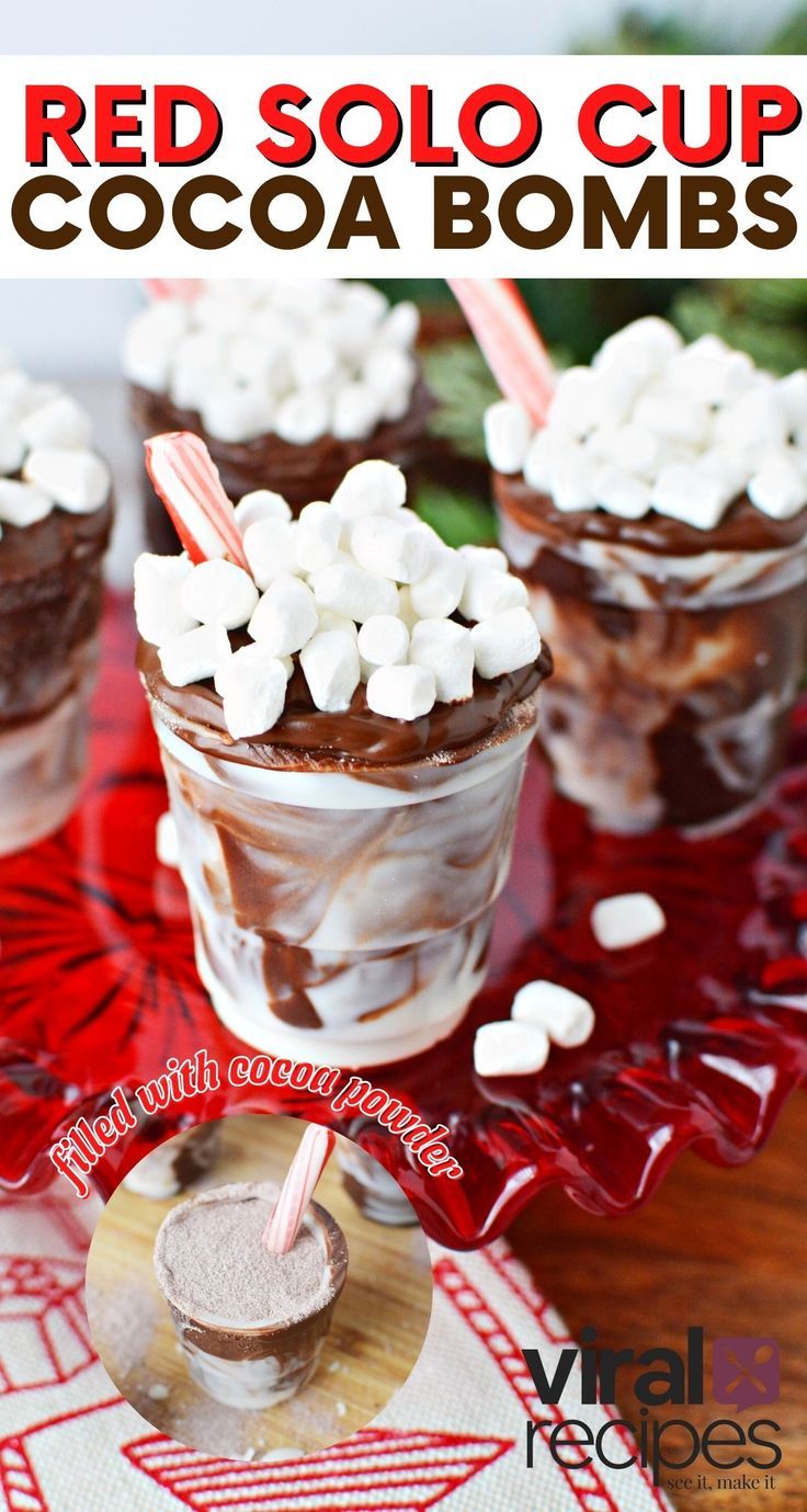 red soloo cups with chocolate and marshmallows in them on a table