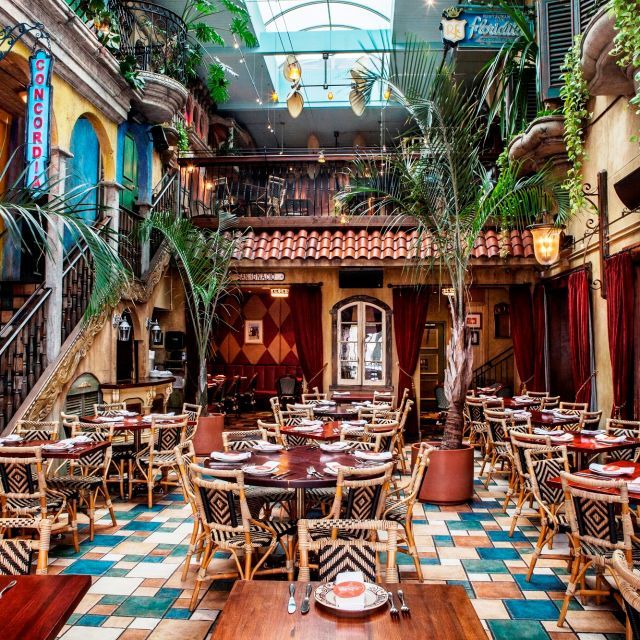 the interior of a restaurant with tables and chairs