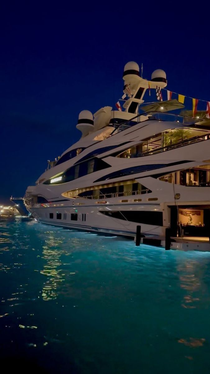 a large white boat in the water at night