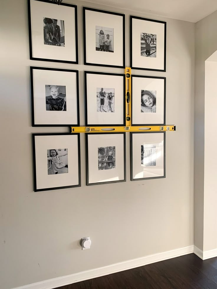 a wall with pictures hanging on it and the words, my trick for hanging the perfect gallery wall