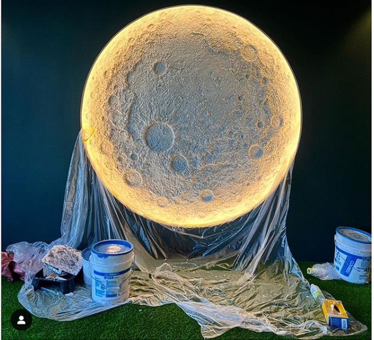 a giant moon is covered with plastic on the ground