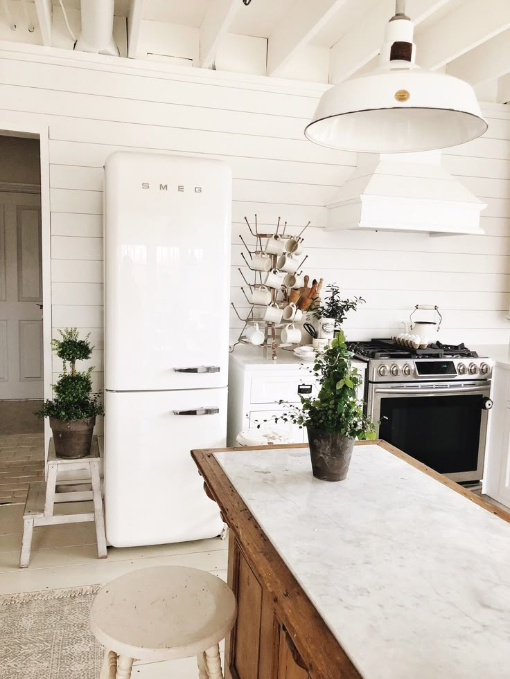 a white refrigerator freezer sitting inside of a kitchen