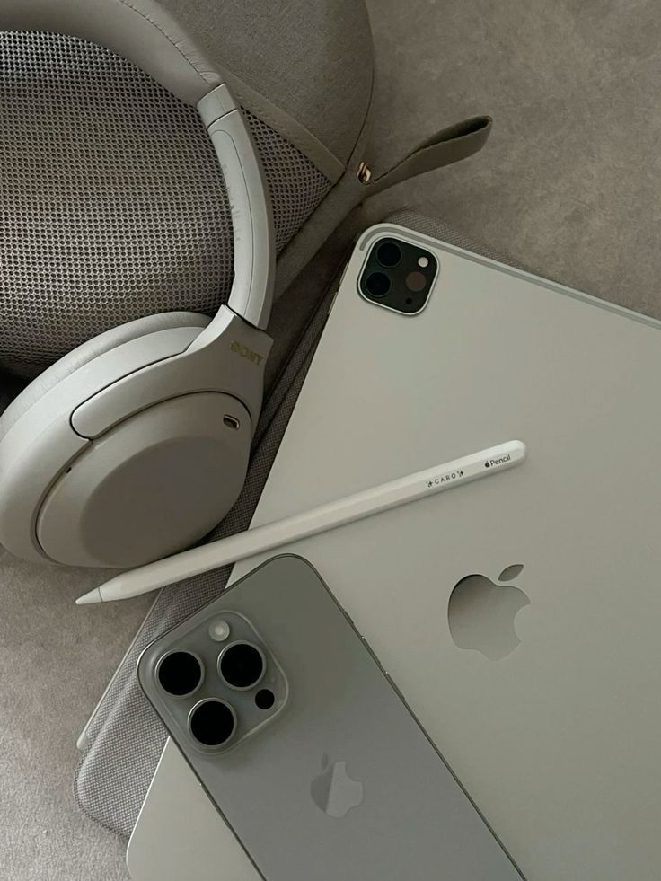 an iphone and headphones are laying on the floor