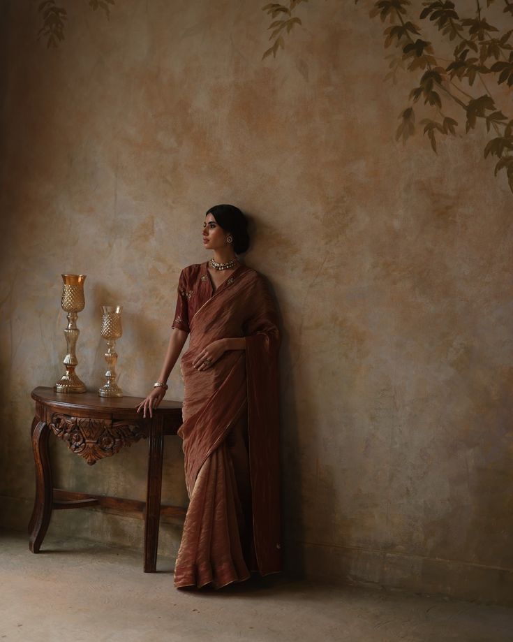 a woman standing next to a table with candles on it