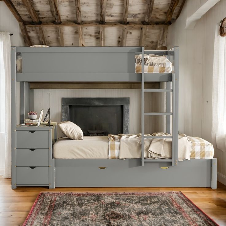 a bunk bed with a fireplace built into the side and drawers underneath it, in a room with wood floors