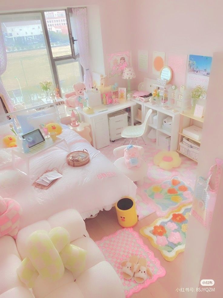 a bedroom with pink walls and white furniture