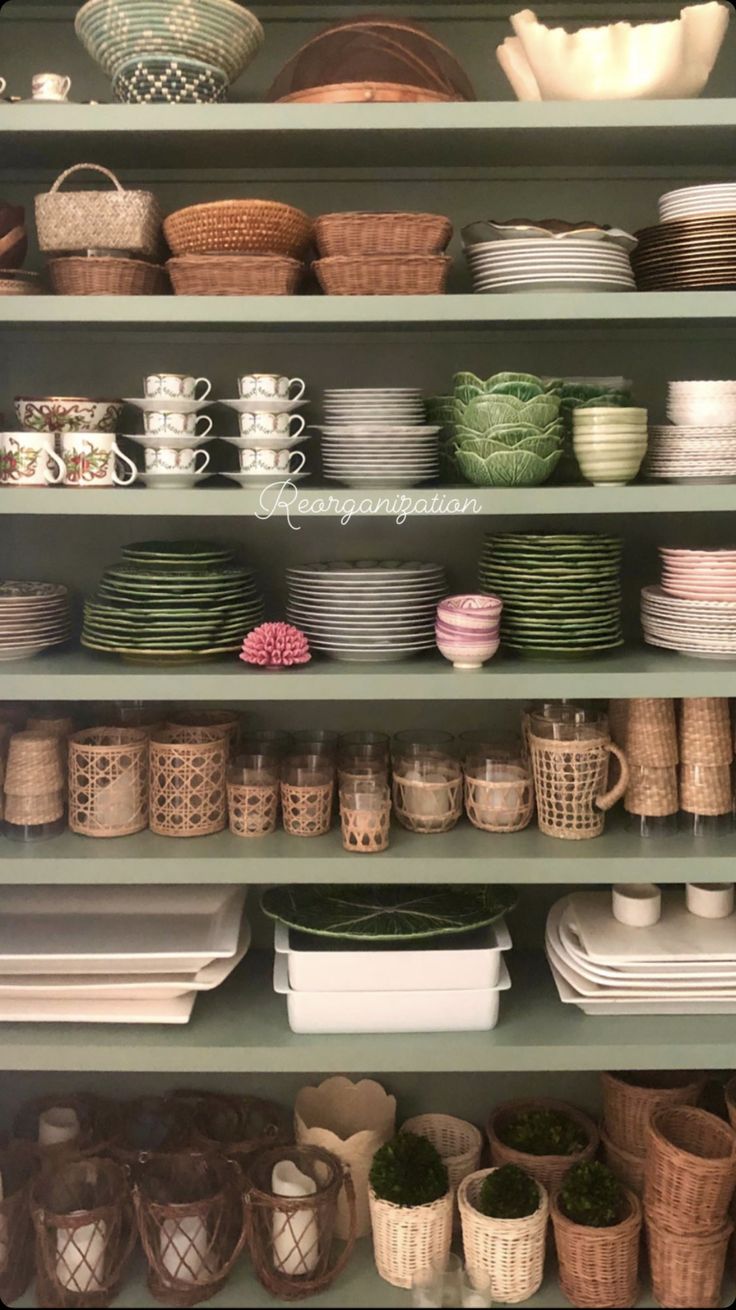 the shelves are filled with dishes and baskets