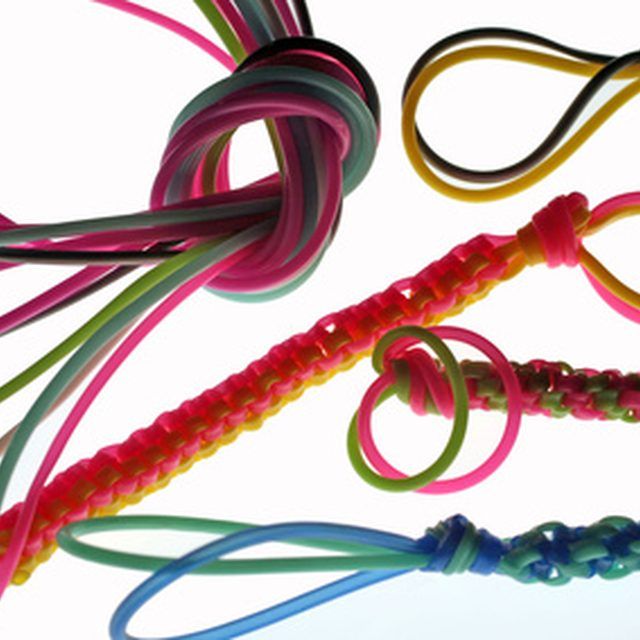 several different colored bracelets are arranged in the shape of an oar and knot