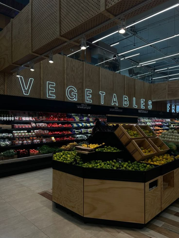 a produce section in a grocery store filled with fruits and vegetables