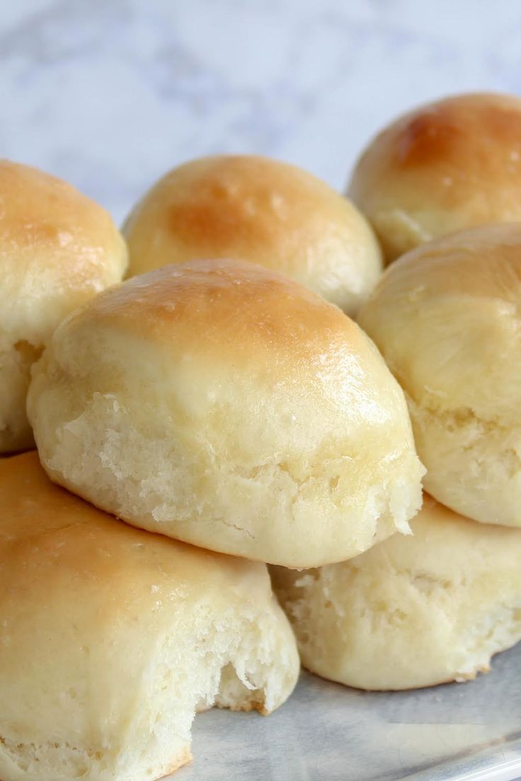 several rolls are stacked on top of each other in a clear plastic container and ready to be eaten