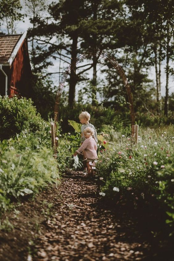 two young children are playing in the woods