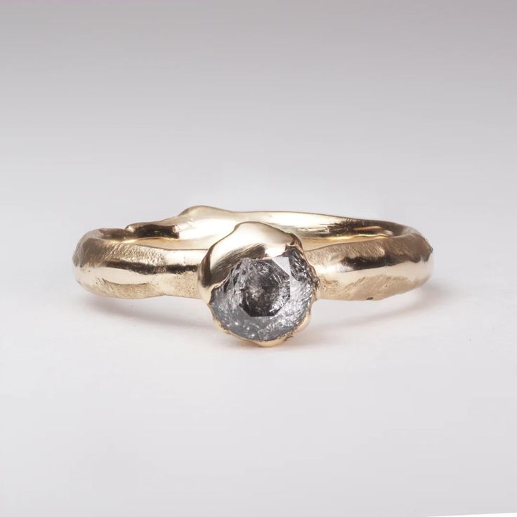 a close up of a gold ring with a diamond