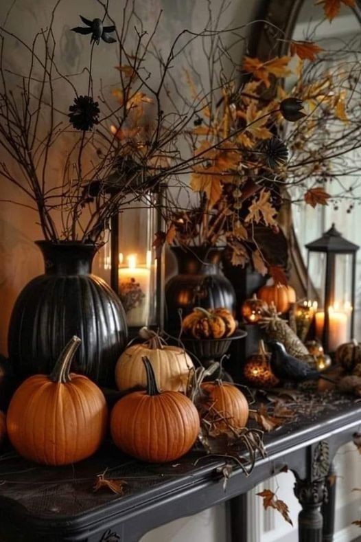 a mantle with pumpkins and candles on it