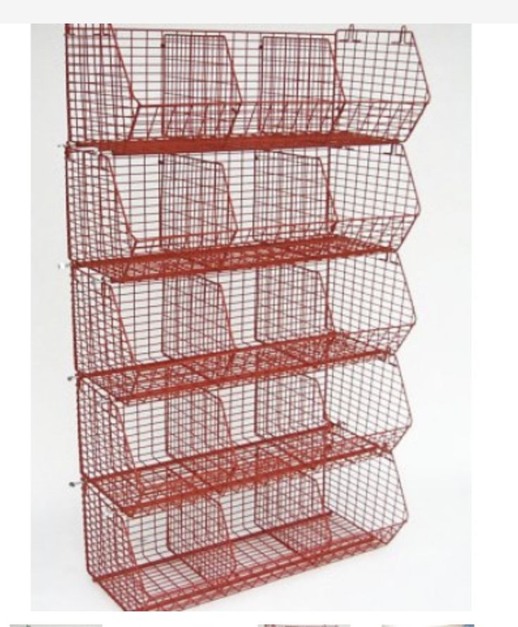 a red wire shelf with four baskets on the top and two shelves below it,