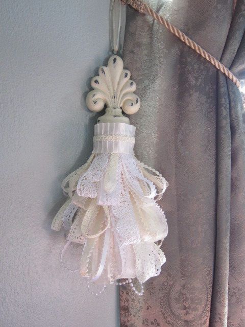 a white lamp hanging from the side of a curtain