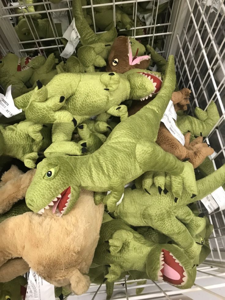 several stuffed animals in a shopping cart with their mouths open and teeth wide open, including alligators