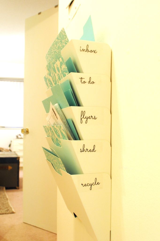 a stack of cards that have been placed in a holder on the wall next to a door