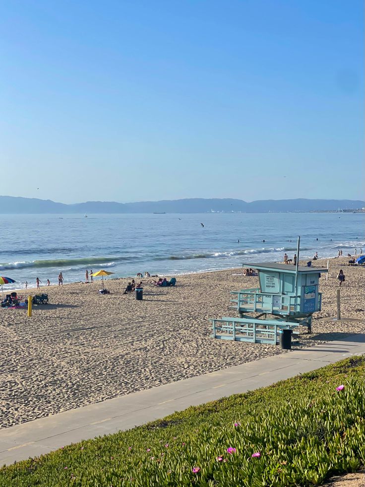 the beach is crowded with people and umbrellas