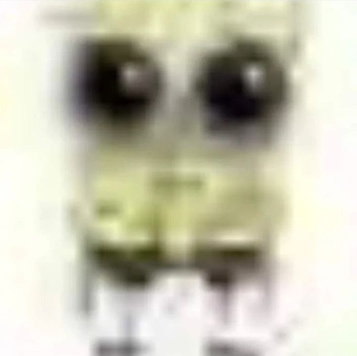 a blurry image of a face with two black eyes and one white eyeball