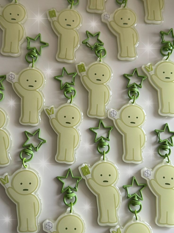 some green and white decorated cookies with leaves on them are arranged in the shape of animals