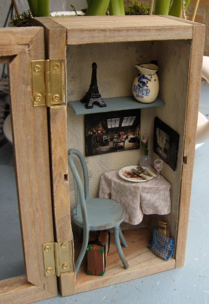 a miniature table and chair in a wooden box