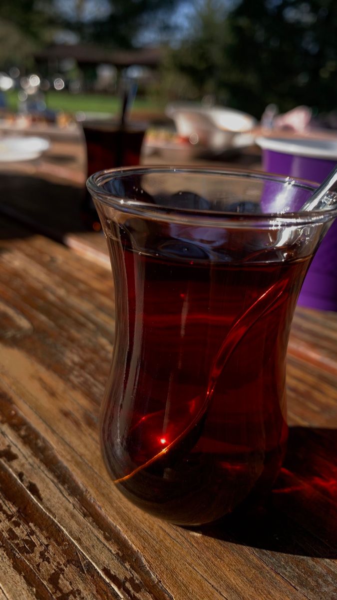 a cup of tea sitting on top of a wooden table