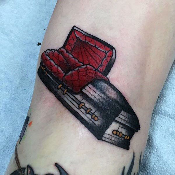 a tattoo on the leg of a person with a red box and spider - man