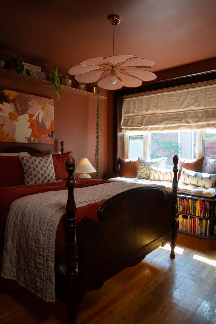 a bed room with a neatly made bed next to a window