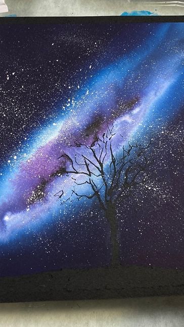 a painting of a tree and the stars in the night sky is being painted on canvases