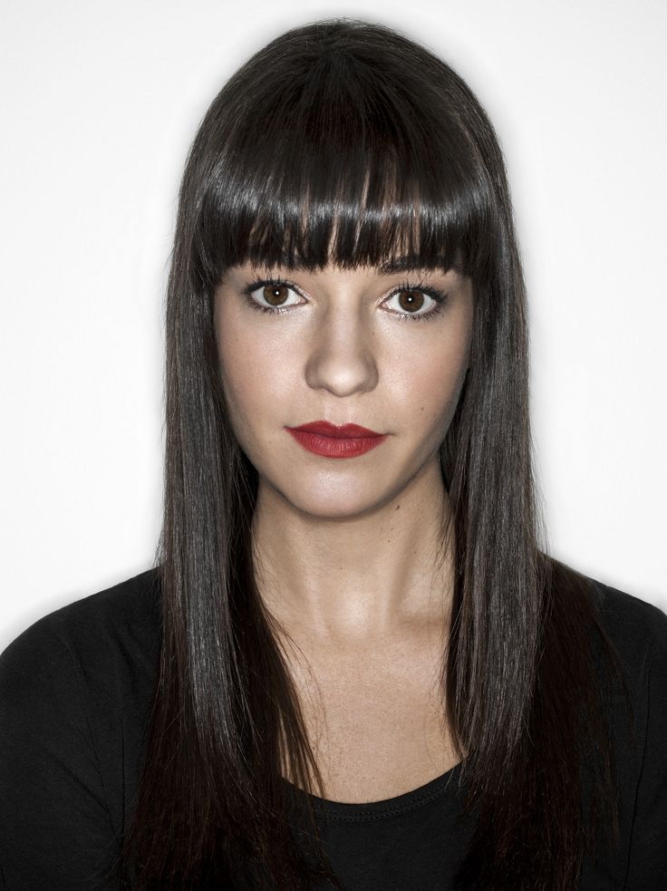 a woman with long black hair and bangs