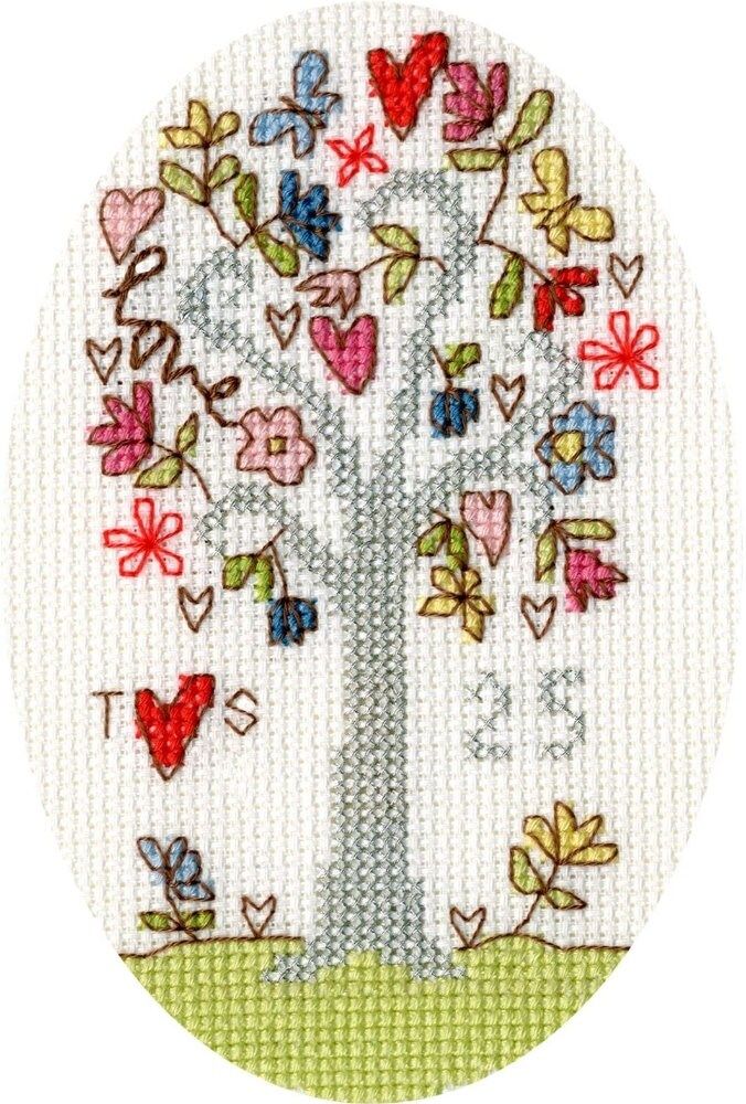 a cross stitch tree with hearts on it