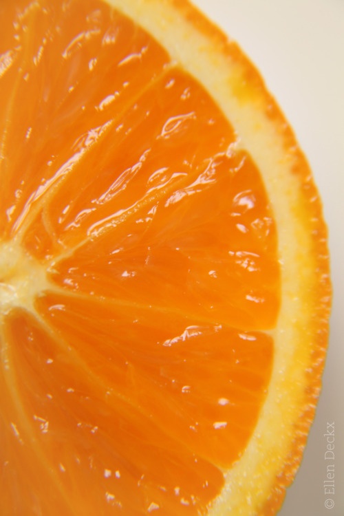 an orange sliced in half on a white surface