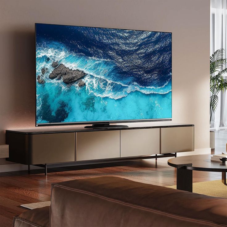 a flat screen tv sitting on top of a wooden entertainment center in a living room