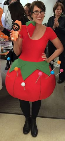 a woman dressed as a strawberry holding a candy bar